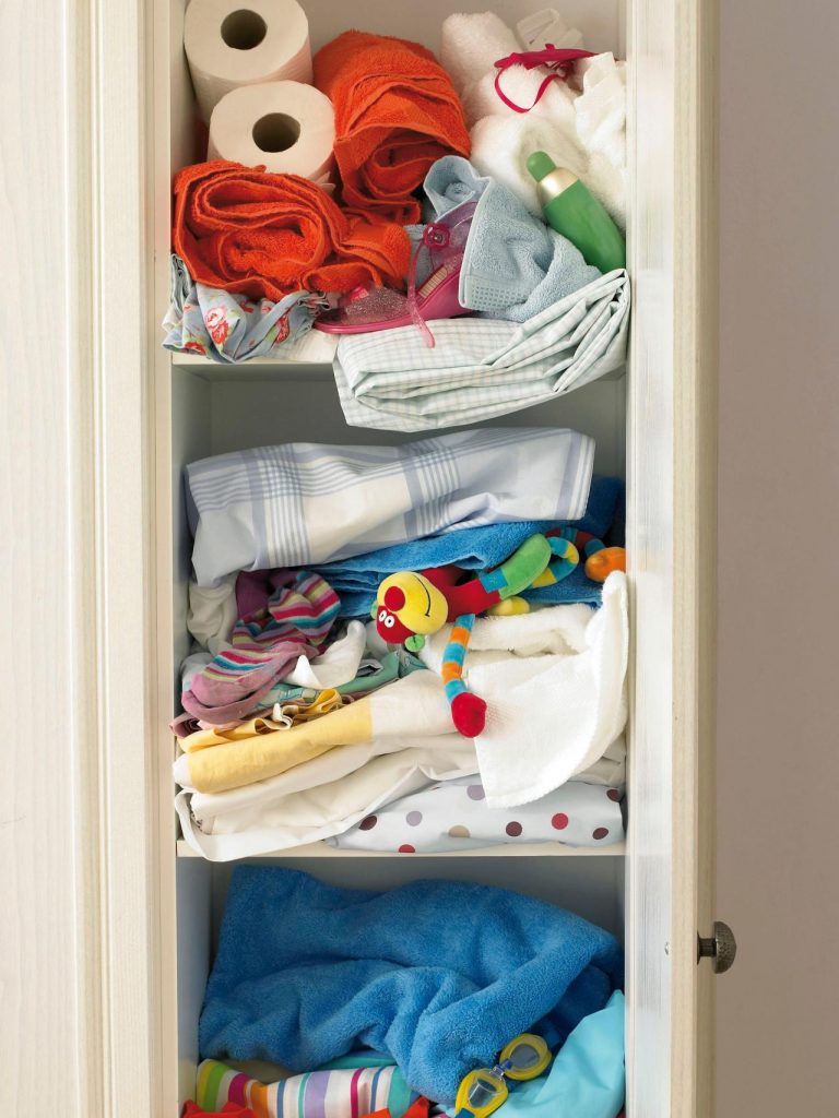 An-over-packed-flooded-messy-linen-closet